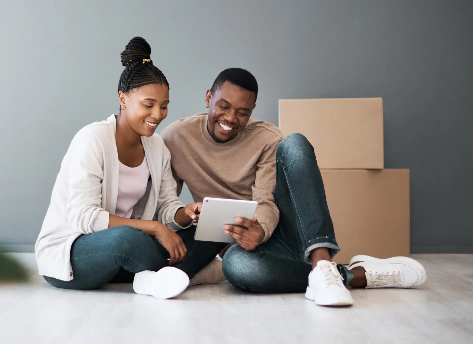 Couple in new home on tablet